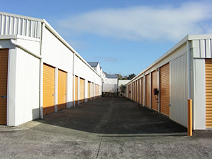 Wide driveway between two rows of drive-up storage units